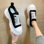 Tread slick black lace up sneakers